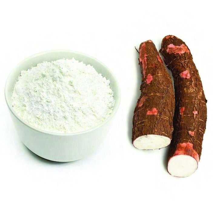 An array of cassava-based products including flour, chips, and packaged goods displayed on a table, highlighting the diverse applications of cassava in food production